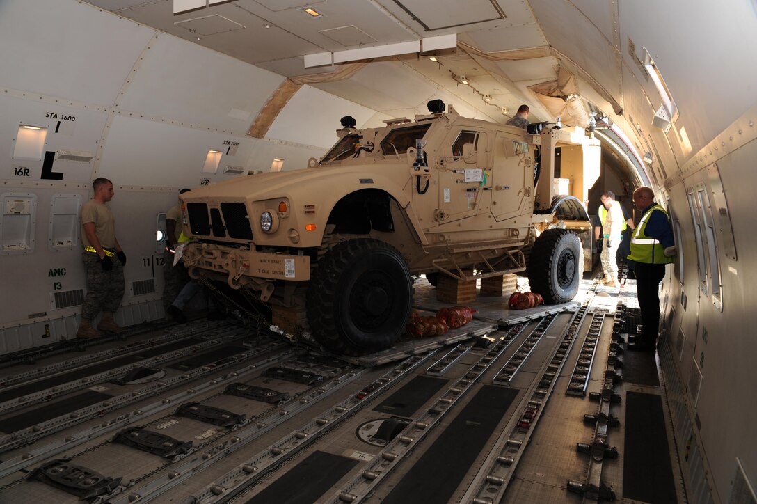 Tie down adjusters are used to secure heavy military equipment, like this mine-resistant ambush protected (MRAP) vehicle, when being transported.  