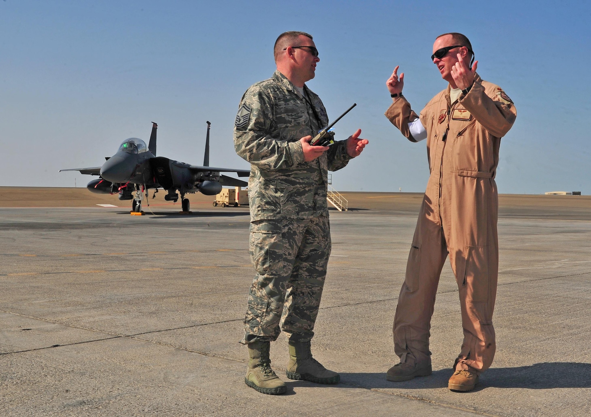 Senior Master Sgt. Bradley, left, 380th Air Expeditionary Wing Inspector General Office director of operations, discusses the concept of casualty triage with Maj. Russel, 380th Expeditionary Medical Group chief of aerospace medicine, during a major accident response exercise at an undisclosed location in Southwest Asia, Jan. 5, 2016. The 380th AEW IG Office began planning for the MARE several months prior to the exercise to ensure the 380th meets annual requirements. (U.S. Air Force photo by Staff Sgt. Kentavist P. Brackin/Released)