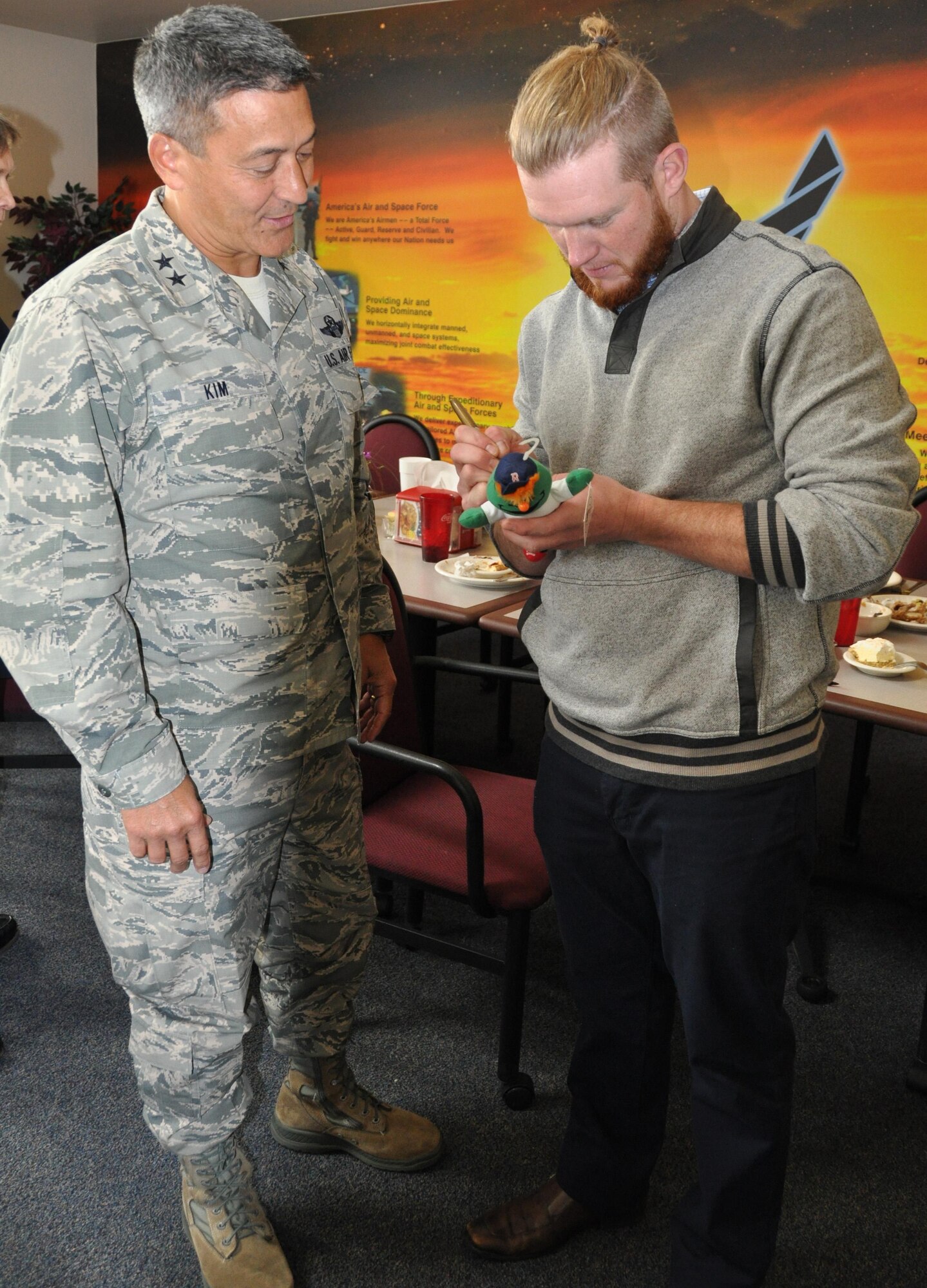 Maj. Gen. Michael Kim, mobilization assistant to the commander, Air Force Reserve Command, gets a memorabilia signed by Boston Red Sox relief pitcher, Craig Kimbrel, following a Spiritual Resiliency luncheon at the Wynn Dining Facility, Robins Air Force Base, Georgia, Jan. 7, 2016. (U.S. Air Force Photo by Capt. Kristin Mack)