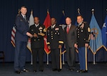 DLA director Air Force Lt. Gen. Andy Busch, left, recognizes DLA Distribution Operation Team Atlanta team member Navy Senior Chief Logistics Specialist Vascoe Rozier III as the Agency’s Joint Reserve Force Senior Enlisted Member of the Year at the 48th annual employee recognition ceremony Dec. 10. Distribution’s commander Army Brig. Gen. Richard Dix, third from right, Robert McCullough, DLA J9 deputy director and DLA Senior Enlisted Leader Army Command Sgt. Maj. Charles Tobin, far right, were also on-hand to present the award. 