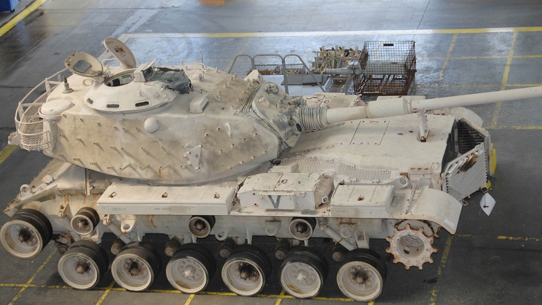 Genesis II, an M60A1 Main Battle Tank, sits in the craneway of Marine Depot Maintenance Command waiting to be refurbished as part of a restoration project between MDMC and the National Museum of the Marine Corps, Sept. 5, 2015. Genesis II and it crew, attached to Company C, 3rd Tank Battalion, Marine Corps Base Twentynine Palms, Calif., spearheaded the Marine attack on the Southern frontier of Kuwait during the opening moments of Operation Desert Storm, earning a permanent place in the museum.