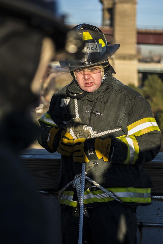 A probationary firefighter in his second week of training at the New York City Fire Academy on Russell Island in New York City, prepares to be lowered down a five-story building during a roof-rope-rescue drill, Jan. 6, 2016. Drill sergeant leaders from the United States Army Drill Sergeant Academy on Fort Jackson, S.C., were at the Fire Academy Jan. 4-8, to observe training as part of a collaboration between the Fire Department of New York and the Center for Initial Military Training providing lessons learned and offering alternate training methods for new recruits. (U.S. Army photo by Sgt. 1st Class Brian Hamilton)
