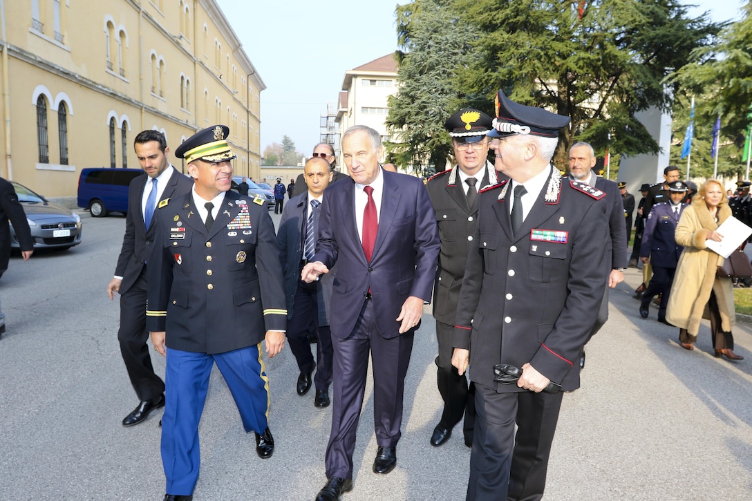 (From left) Col. Darius Gallegos, CoESPU deputy director and U.S. Army Africa liaison, Amb. John Phillips, U.S. Ambassador to Italy, and Italian Lt. Gen. Tullio del Sette, Carabinieri general commander, lead attendees to a banquet during a ceremony marking the 10th anniversary of the Center of Excellence for Stability Police Units, Dec. 1, at General A. Chinotto barracks, Vicenza, Italy. Since the center’s establishment, the U.S. has provided assistance in support of police peacekeeping training at CoESPU. To date, the center has trained over 5,000 leaders and trainers from more than 30 geographically and culturally diverse countries. (U.S. Army Africa photo by Staff Sgt. Lance Pounds)