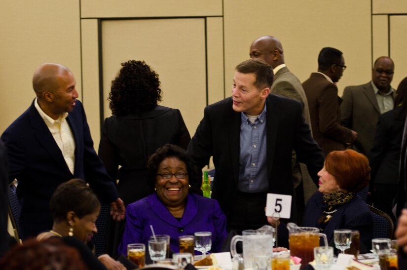 Lt. Gen. Jeffrey Talley, commanding general, U.S. Army Reserve, laughs with Command Sgt. Maj. Luther Thomas, Jr., 12th Command Sergeant Major, U.S. Army Reserve, and family members as Thomas bids farewell to colleagues and friends during a dinner in his honor at the Iron Mike Conference Center at Fort Bragg, N.C., Jan. 7, 2016. Thomas, who has been in the position since 2013, prepares for a transition into a new role as senior enlisted adviser to the assistant secretary of defense for manpower and reserve affairs. (U.S. Army photo by Brian Godette/Released)