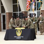 U.S. Army Contracting Command leadership cut the cake during the ribbon-cutting ceremony held at Redstone Arsenal, Alabama, to celebrate the completion of their newly renovated headquarters building Jan. 7.