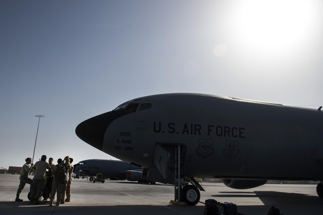 U.S. airmen talk with maintainers before a refueling operation in a KC-135 Stratotanker aircraft from Al Udeid Air Base, Qatar, Jan. 6, 2016. The airmen are assigned to the 340th Expeditionary Air Refueling Squadron. The operation is part of the coalition's counter-ISIL efforts. U.S. Air Force photo by Staff Sgt. Corey Hook