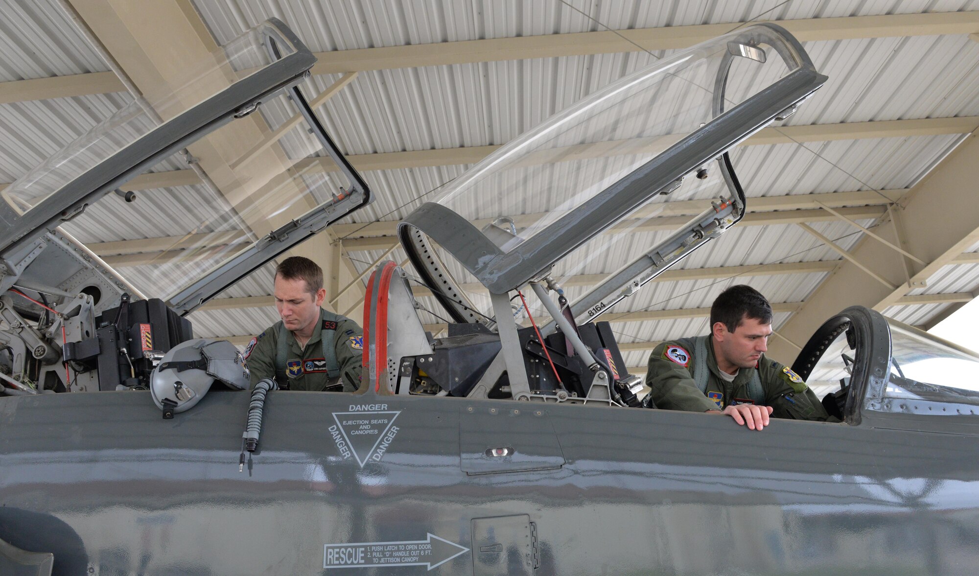 Capt. Chris Umphres, a 435th Fighter Training Squadron flight commander and instructor pilot, conducts a preflight check of a T-38 with 1st Lt. Kaleb Jenkins, a 435th FTS student pilot, before a training mission Jan. 5, 2016, at Joint Base San Antonio-Randolph, Texas. (U.S. Air Force photo/Tech. Sgt. Beth Anschutz)