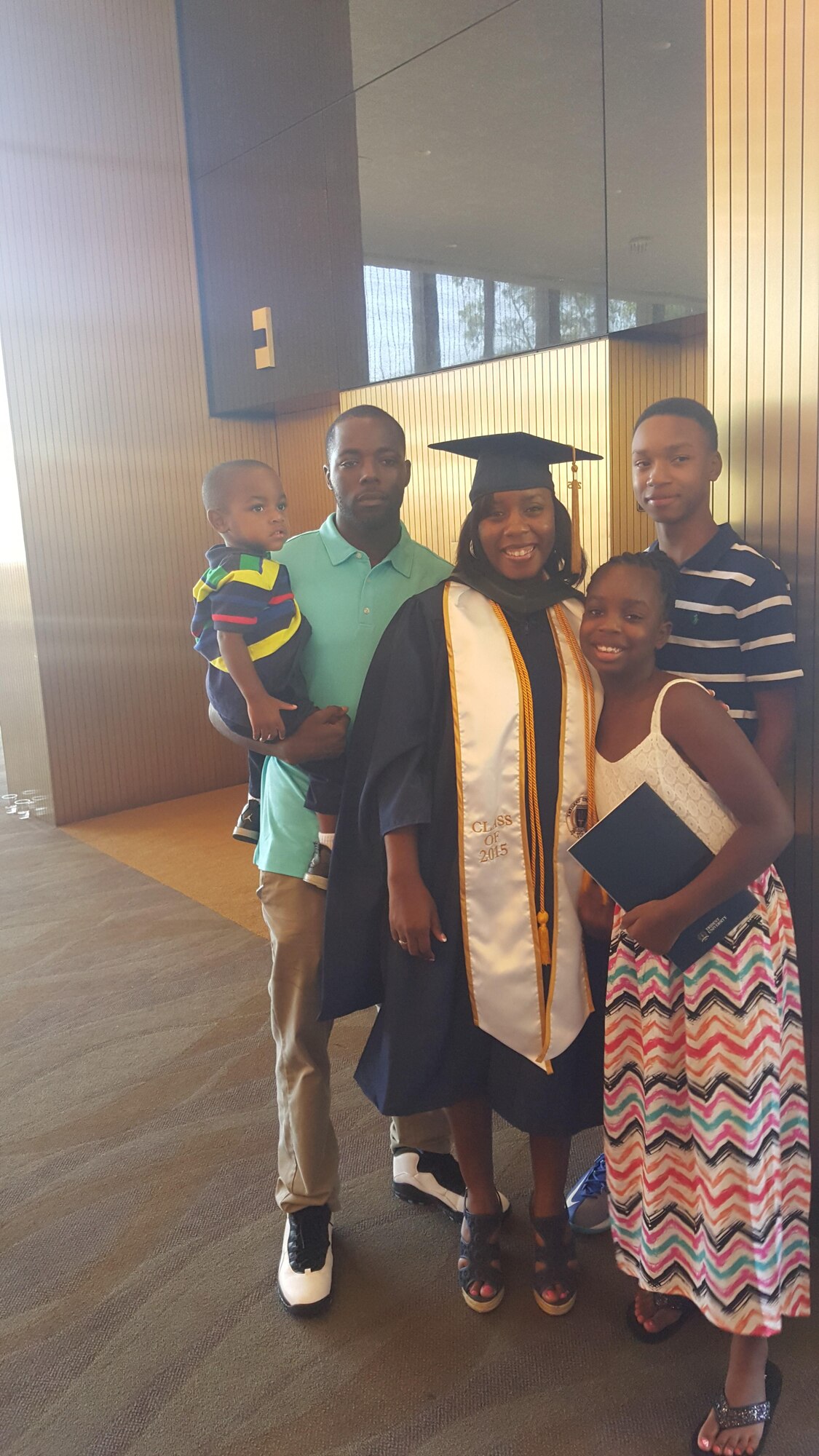 Master Sgt. Alicia Barley, Community College of the Air Force regional manager, poses for a photo with her family after receiving her Master of Science in Health Administration degree from Trident University in 2015. Sergeant Barley graduated with honors, Magna Cum Laude, while continuing her job serving Airmen at Air University. (U.S. Air Force courtesy photo)