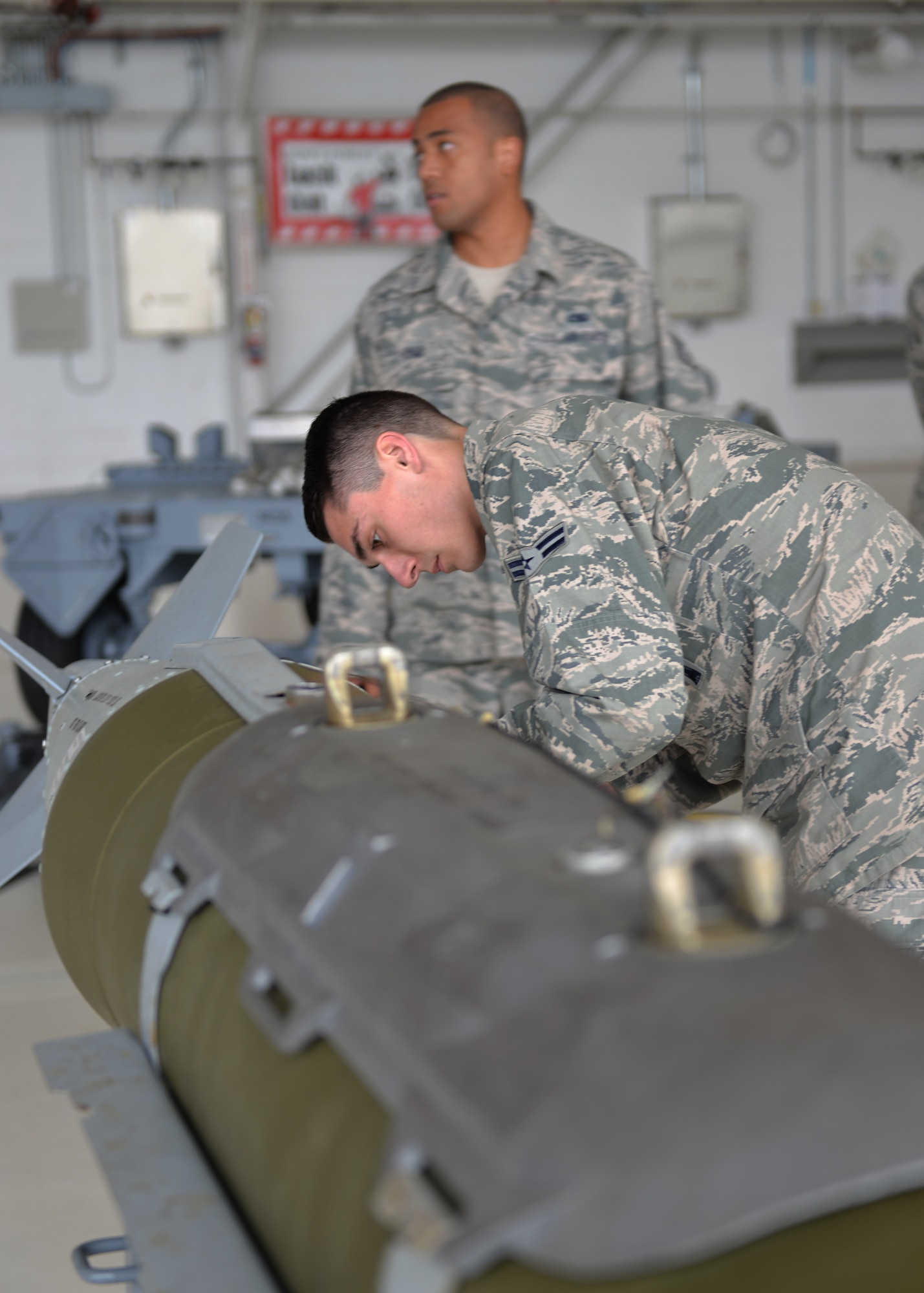 Airmen 1st Class Jacob Robinson, 33rd Aircraft Maintenance Squadron weapons load crew member, check over a Guided Bomb Unit during a load competition at Eglin Air Force Base, Fla., Jan. 8, 2016. During this event teams are evaluated on the level of safety, efficiency and speed displayed while loading munitions.  (U.S. Air Force Photo/Senior Airman Andrea Posey)