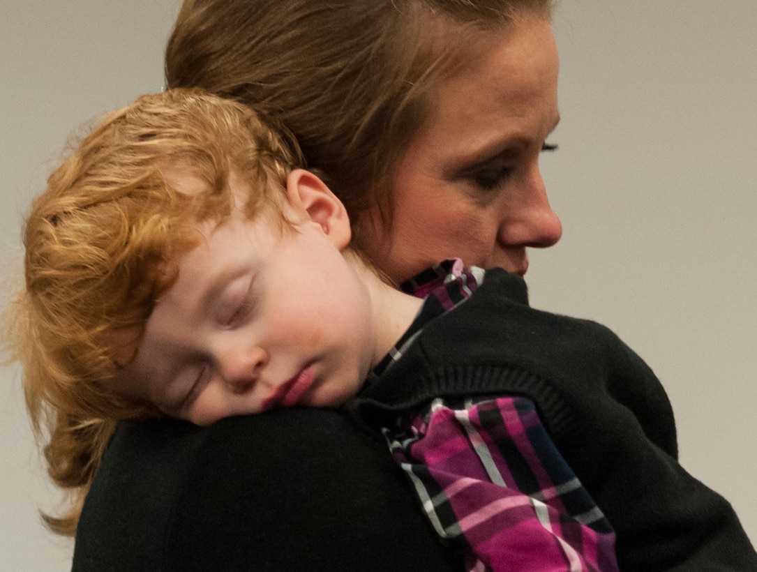 Aaron Wills, son of Command Sgt. Maj. James P. Wills, naps on the shoulder of his mother, Lisa, during her husband's change of responsibility ceremony at the U.S. Army Forces Command and U.S. Army Reserve Command headquarters, Jan. 8, 2016, at Fort Bragg, N.C. Wills takes over the U.S. Army Reserve's top enlisted position from Command Sgt. Maj. Luther Thomas Jr. who will be the senior enlisted adviser to the assistant secretary of defense for Manpower and Reserve Affairs. (U.S. Army photo by Timothy L. Hale/Released)
