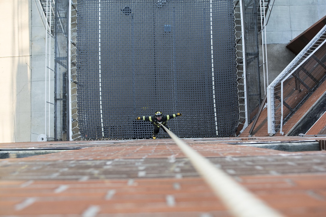 A probationary firefighter in his second week of training at the New York City Fire Academy on Russell Island in New York City, is lowered down a five-story building during a roof-rope-rescue drill, Jan. 6, 2016. Drill sergeant leaders from the United States Army Drill Sergeant Academy on Fort Jackson, S.C., were at the Fire Academy Jan. 4-8, to observe training as part of a collaboration between the Fire Department of New York and the Center for Initial Military Training providing lessons learned and offering alternate training methods for new recruits. (U.S. Army photo by Sgt. 1st Class Brian Hamilton)