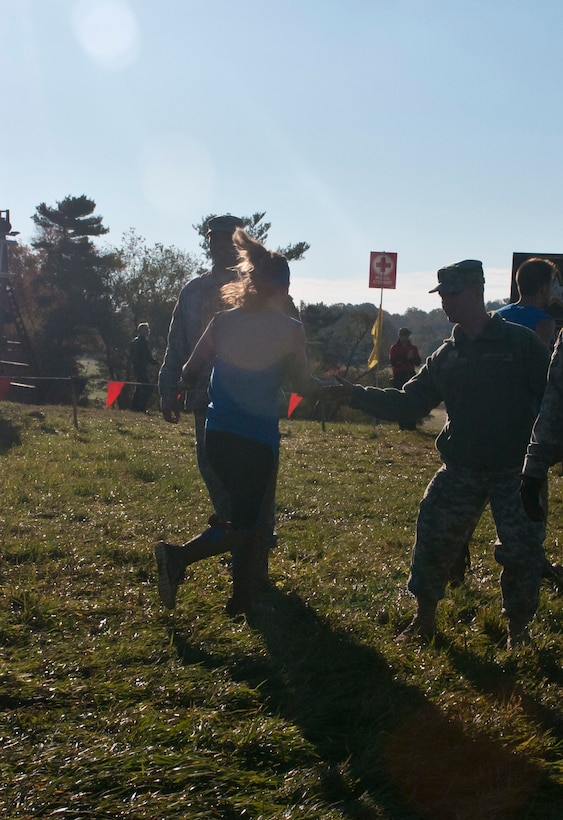 U.S. Army Reserve Pvt. Anthony Diamanti, 369th Engineer Detachment (Firefighting), a military and civilian firefighter from Berlington, N.J., offers encouragement to Tough Mudders during Tough Mudder Philly in Coatesville, Pa., Oct. 17. (U.S. Army photo by Staff Sgt. Debralee Best)