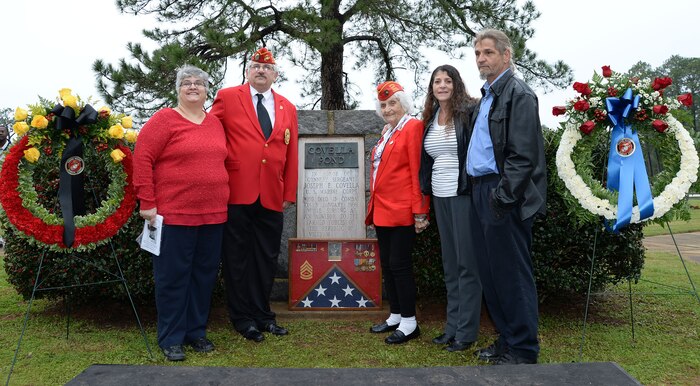 Members of the Covella family pose for a photo in front of a bronze plaque mounted on a marble monument honoring the late Gunnery Sgt. Joseph Covella, Jan. 8. Covella was mortally wounded while serving as an advisor to the Armed Forces of the Republic of Vietnam, Jan. 3, 1966. The base pond was officially named “Covella Pond” Sept. 23, 1969.