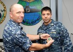 SAN DIEGO (Jan. 8, 2016) - Capt. Gene Doyle, commander, Submarine Squadron 11, awards Senior Chief Electronics Technician John Montgomery with a Navy and Marine Corps Achievement Medal for his heroic actions in a vehicle accident the previous week. Montgomery administered CPR to a man who had suffered a heart attack while driving on New Year's Day. U.S Navy Photo by Mass Communication Specialist 2nd Class Kyle Carlstrom (Released)