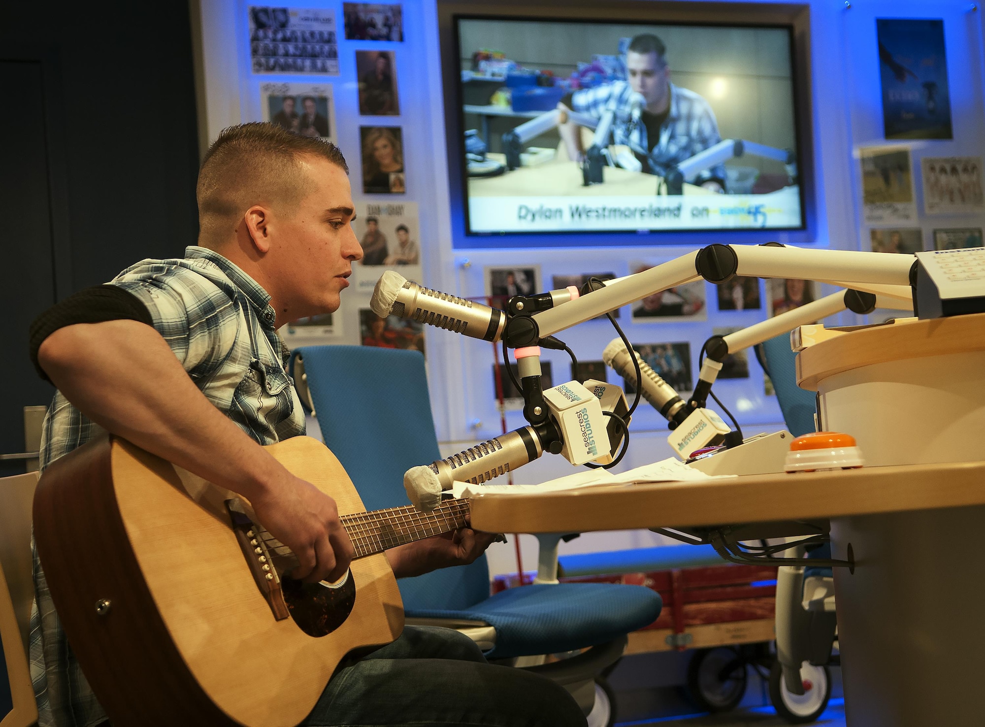 Airman 1st Class Dylan Westmoreland, 790th Quick Response Force, performs on a broadcast at the Children's Hospital Colorado in Aurora, Colorado, Jan. 6, 2015. Westmoreland participated in various discussions with the staff and children throughout the day. (U.S. Air Force photo by Airman 1st Class Malcolm Mayfield)