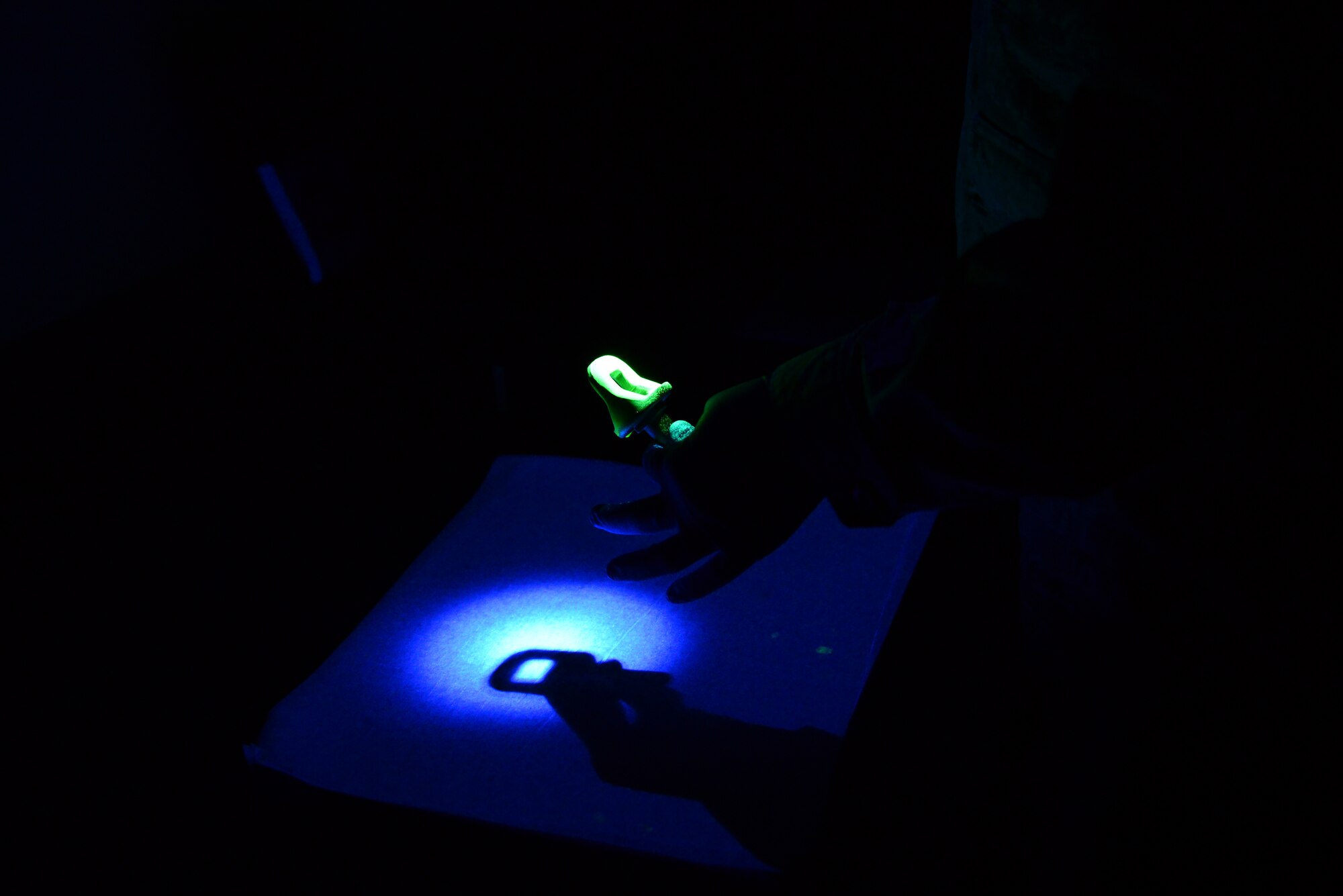 U.S. Air Force Airman 1st Class Christopher Reynolds Jr., a 354th Maintenance Squadron nondestructive inspection journeyman, uses an ultraviolet light to find cracks in a part Jan. 6, 2016, at Eielson Air Force Base, Alaska. The process takes place by using an oil, and if any cracks are in the part, the oil is drawn into the crack and is seen when he wipes the excess oil away. (U.S. Air Force photo by Airman 1st Class Cassandra Whitman/Released)