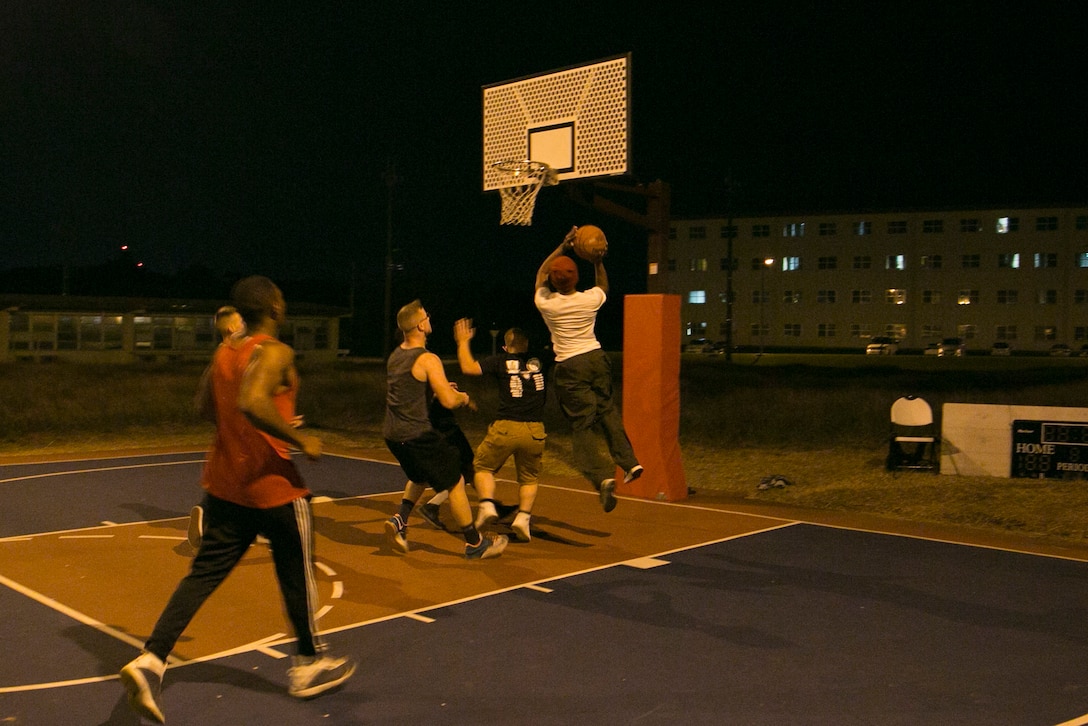 Status of Forces Agreement personnel participate in a basketball game Jan. 1 on Marine Corps Air Station Futenma, Okinawa, Japan. The basketball game provided a safe alternative to drinking on New Year’s. Approximately 30 people participated in the game, which was hosted by Futenma’s Single Marine Program and Navy Lt. Yonina E. Creditor, the station chaplain for MCAS Futenma. (Marine Corps Photo by Lance Cpl. Douglas D. Simons/Released)