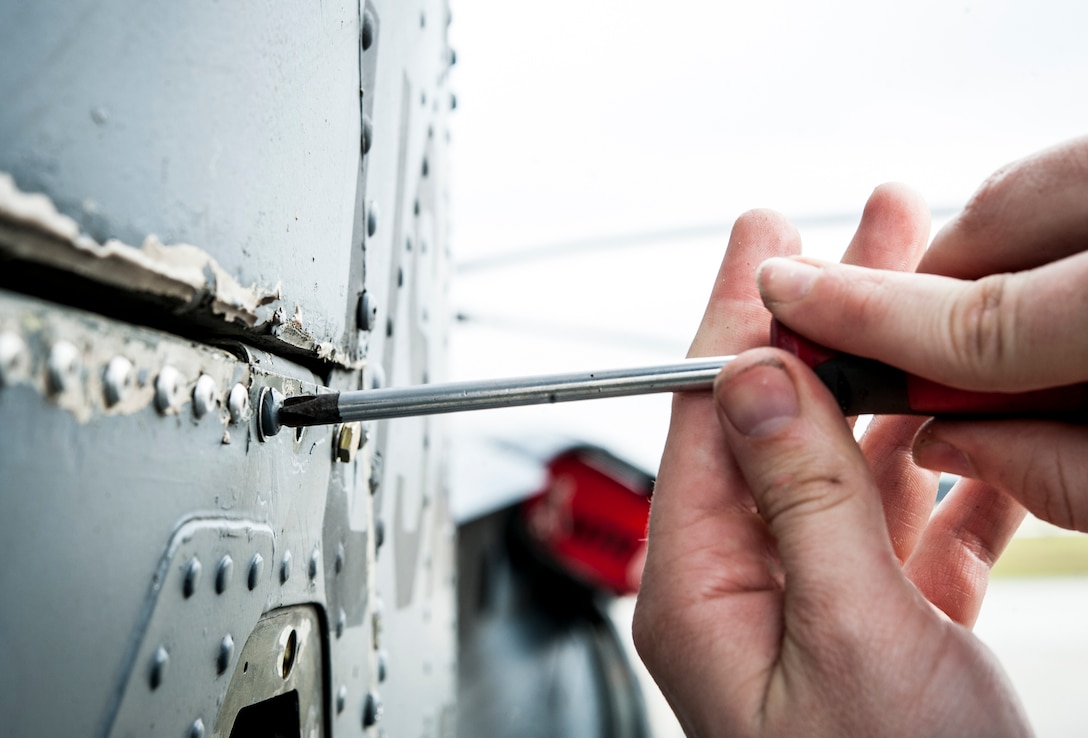 An Airman of the 41st Helicopter Maintenance Unit reassembles the tail end of an HH-60G Pave Hawk after repairs, Jan. 6, 2016, at Moody Air Force Base, Ga. The 41st HMU performs regular maintenance on all HH60Gs stationed here to maintain readiness for each new mission. (U.S. Air Force photo by Airman 1st Class Lauren M. Johnson/Released)