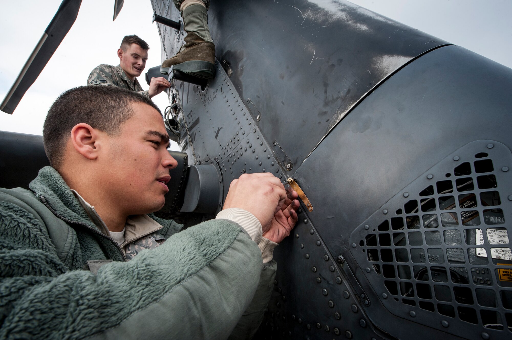 U.S. Air Force Senior Airman Nicholas Rodriguez and Airman 1st Class Derek Fischer, 41st Helicopter Maintenance Unit, reassemble the tail end of an HH-60G Pave Hawk after repairs, Jan. 6, 2016, at Moody Air Force Base, Ga. Airmen of the 41st HMU work together  to get the HH-60G operational and back to flying status. (U.S. Air Force photo by Airman 1st Class Lauren M. Johnson/Released)