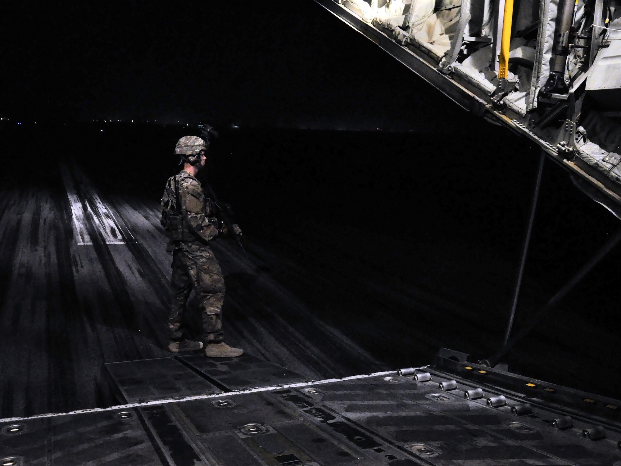 Airman 1st Class Seth Seward, 455th Expeditionary Security Forces Squadron Fly Away Security Team Defender, deployed from Offutt Air Force Base, Neb.,  secures the rear entrance of a C-130 Hercules during a mission to Jalalabad Airfield, Afghanistan Dec. 18, 2015. The 455th ESFS FAST is the all-encompassing security team that provides ground safety and cockpit denial to protect the aircraft and crew. (U.S. Air Force photo by Tech. Sgt. Nicholas Rau)