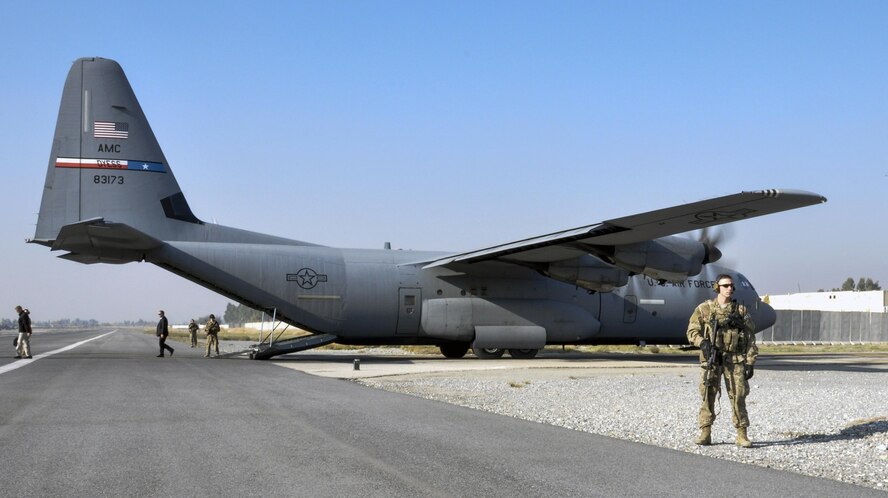 Staff Sgt. Tyler Berogan, 455th Expeditionary Security Forces Squadron Fly Away Security Team squad lead, deployed from Offutt Air Force Base, Neb.,  right, secures the flightline with his team at Jalalabad Airfield, Afghanistan Dec. 18, 2015. The 455th ESFS FAST is the all-encompassing security team that provides ground safety and cockpit denial to protect the aircraft and crew. (U.S. Air Force photo by Tech. Sgt. Nicholas Rau)