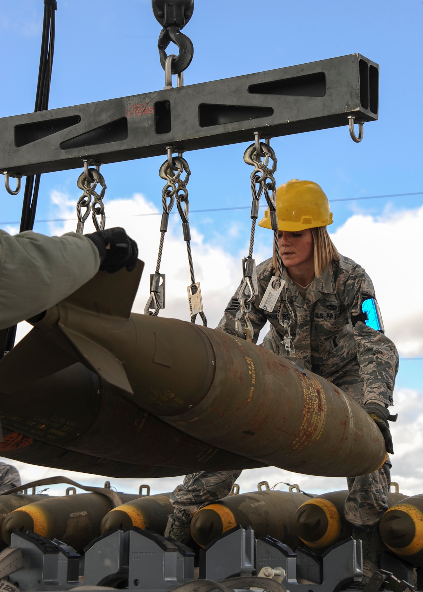 U.S. Air Force Staff Sgt. Nicole Navarro, 355th Equipment Maintenance Squadron munitions flight conventional maintenance crew chief, offloads bombs from the munitions assembly conveyer at Davis-Monthan Air Force Base, Ariz., Jan. 8, 2016.  The munitions crew built a total of 36 bombs: six Mark 84s and 30 Mark 82s. (U.S. Air Force photo by Airman Basic Nathan H. Barbour/Released)
