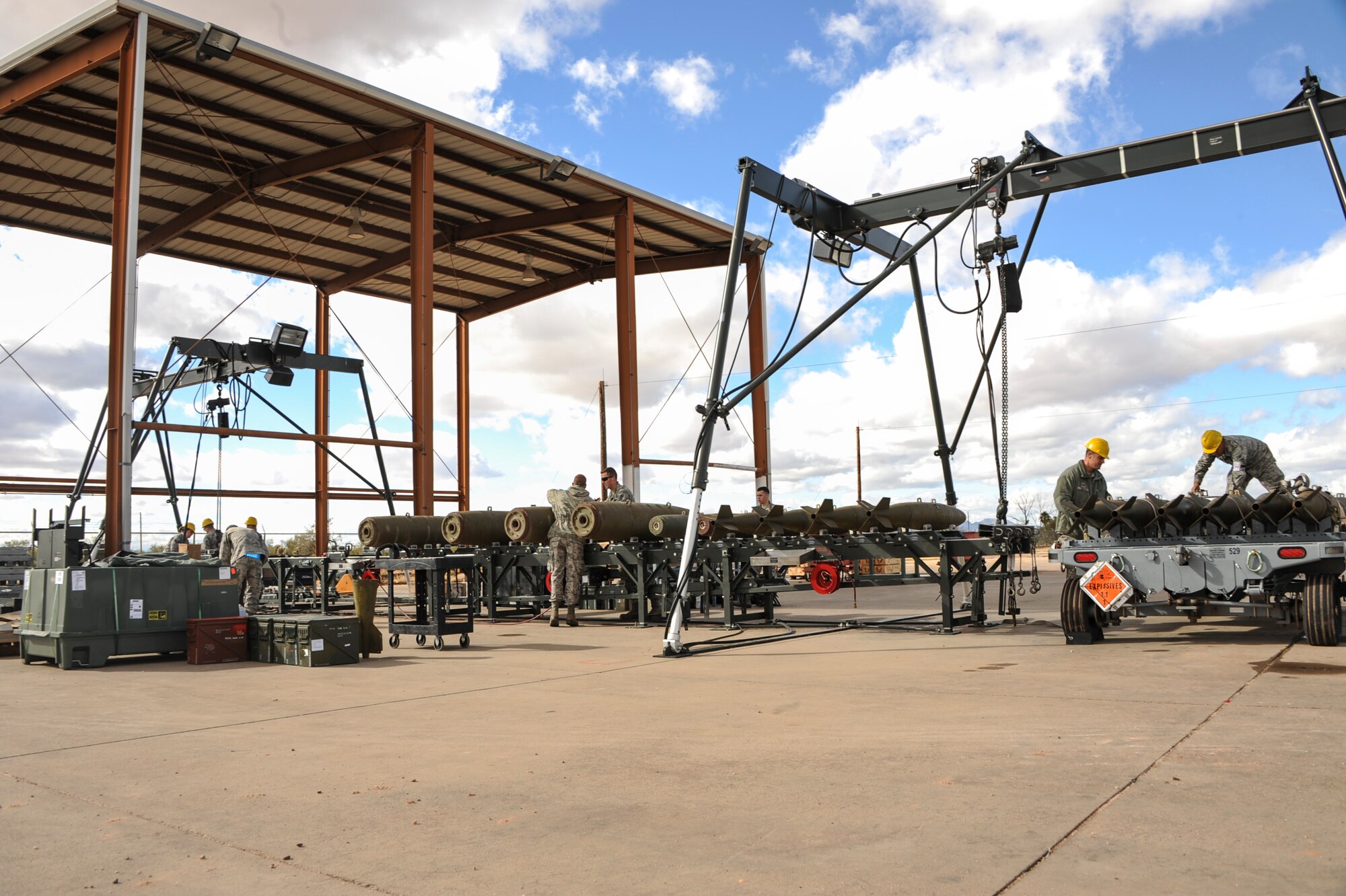 U.S. Airmen from the 355th Equipment Maintenance Squadron work to assemble bombs at Davis-Monthan Air Force Base, Ariz., Jan. 8, 2016. The Airman built a total of 36 bombs: six Mark 84s and 30 Mark 82s. (U.S. Air Force photo by Airman Basic Nathan H. Barbour/Released)