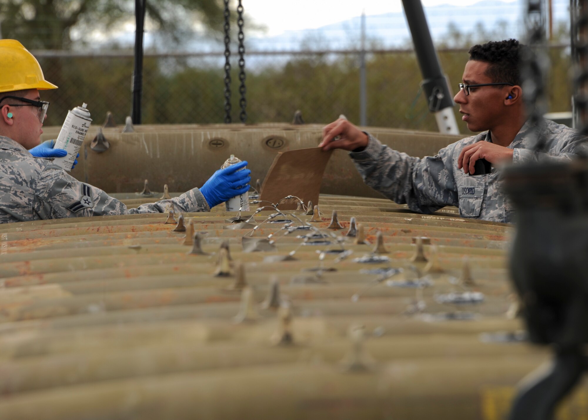 U.S. Air Force Senior Airman Krisjan Osorio, 355th Equipment Maintenance Squadron line delivery crew member, and Airman 1st Class Justin Claiborn, , 355th EMS munitions flight conventional maintenance crew member, apply weapon stock numbers to Mark 82 bombs at Davis-Monthan Air Force Base, Ariz., Jan. 8, 2016. The Airmen also applied a marking with the fuse setting so the loaders on the flightline can verify that the fuse is set to the correct settings. (U.S. Air Force photo by Airman Basic Nathan H. Barbour/Released)