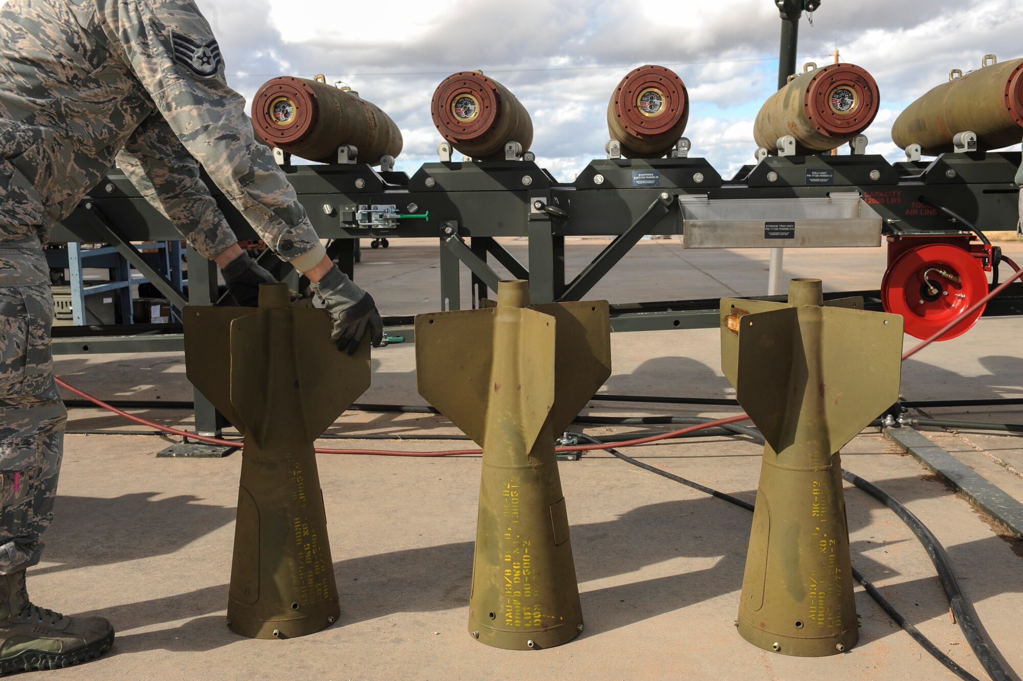 A U.S. Airman prepares to attach fins to a Mark 82 bomb at Davis-Monthan Air Force Base, Ariz., Jan. 8, 2016. The bombs were loaded onto a munitions assembly conveyer where it was assembled.(U.S. Air Force photo by Airman Basic Nathan H. Barbour/Released)