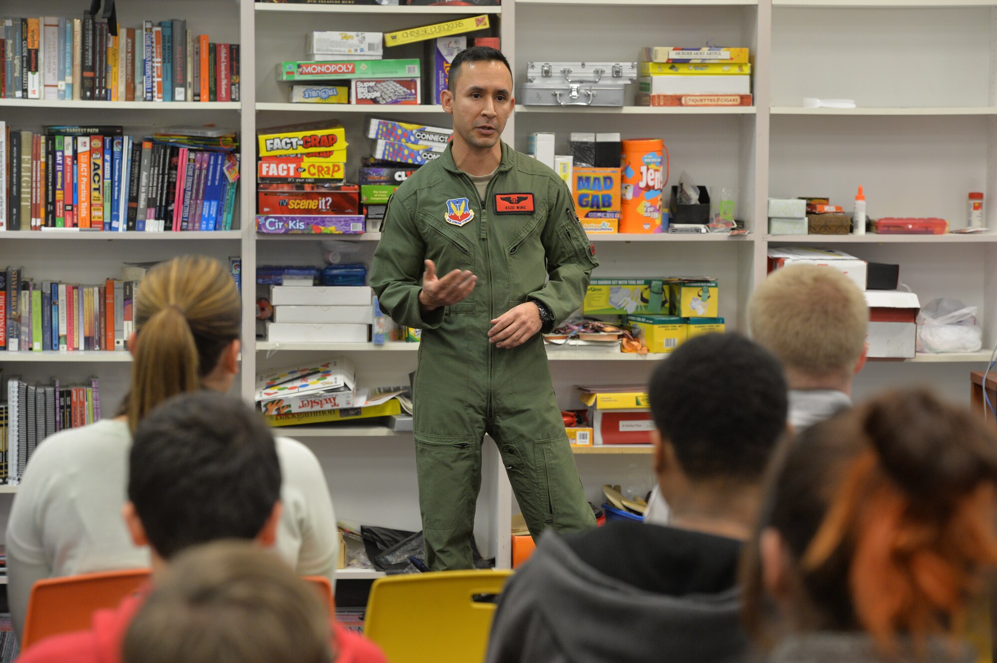 Tech. Sgt. Gabriel with the 432nd Wing/432nd Air Expeditionary Wing speaks to kids about the opportunities the Air Force has during Career Day on Jan. 7, 2016 at the Boys and Girls Club, Las Vegas, Nevada. Gabriel elaborated on their jobs and answered important questions about the Air Force mission. They pass out 432nd Wing patches as memorandum from their visit and played a video describing the importance of remotely piloted aircraft in the war on terrorism. (U.S. Air Force photo by Senior Airman Adarius Petty/released).