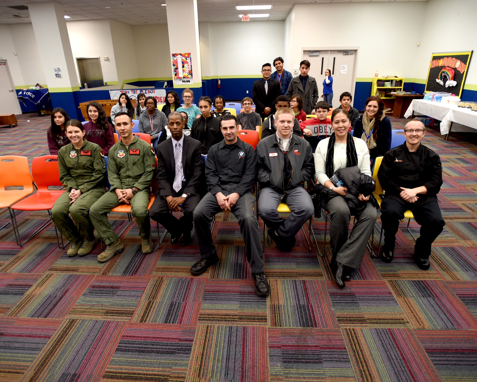 Capt. Angela, 432nd Wing/ 432 Expeditionary Wing, left, and Tech. Sgt. Gabriel, 42nd W/ 432 AEW, pose with other guest speakers Jan. 7, 2016 during Career Day at Boys and Girls Club in Las Vegas, Nevada Jan. 7, 2016. Gabriel and Angela spoke to the youth members about their jobs and answered important questions about the Air Force mission. The two passed out 432nd Wing patches as memorabilia of their visit and presented a video explaining the importance of remotely piloted aircraft in the war on terrorism. (U.S. Air Force photo by Airman 1st Class Kristan Campbell/released).