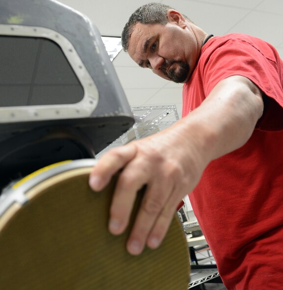 Robert Graham, 402nd Electronics Maintenance Group electronics mechanic, troubleshoots part of a Sniper Pod at the Avionics Complex here. Sniper is an electro-optical targeting system in a single, lightweight pod that is compatible with the latest precision-guided weapons for detecting, identifying and engaging multiple moving and fixed targets in air-to-air and air-to-ground engagements. (U.S. Air Force photo by Tommie Horton)