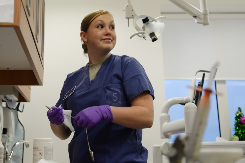 Senior Airman Alicia Rosdahl, a dental technician with the 423rd Medical Squadron, cleans up after seeing a patient at the RAF Alconbury, United Kingdom, Dental Clinic, Jan. 6, 2015. As a dental technician Rosdahl takes care of much of the behind-the-scenes work for a dental appointment, including: cleaning and sanitizing tools, wiping down and disinfecting surfaces and disposing of any non-reusable equipment. (U.S. Air Force photo by Airman 1st Class Zachary Bumpus/Released)