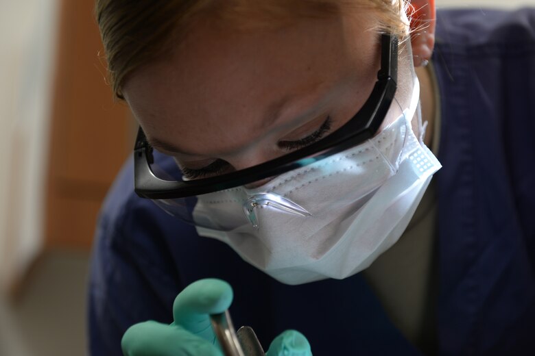 Senior Airmen Alicia Rosdahl, a dental technician with the 423rd Medical Squadron, makes final adjustments to a patient’s braces to ensure no discomfort is caused by protruding wires, during a checkup at the RAF Alconbury, United Kingdom, Dental Clinic, Jan. 6, 2015. Rosdahl uses her position as a dental technician to gain insight and experience that will help her achieve her goal of one day becoming a dentist. (U.S. Air Force photo by Airman 1st Class Zachary Bumpus/Released)