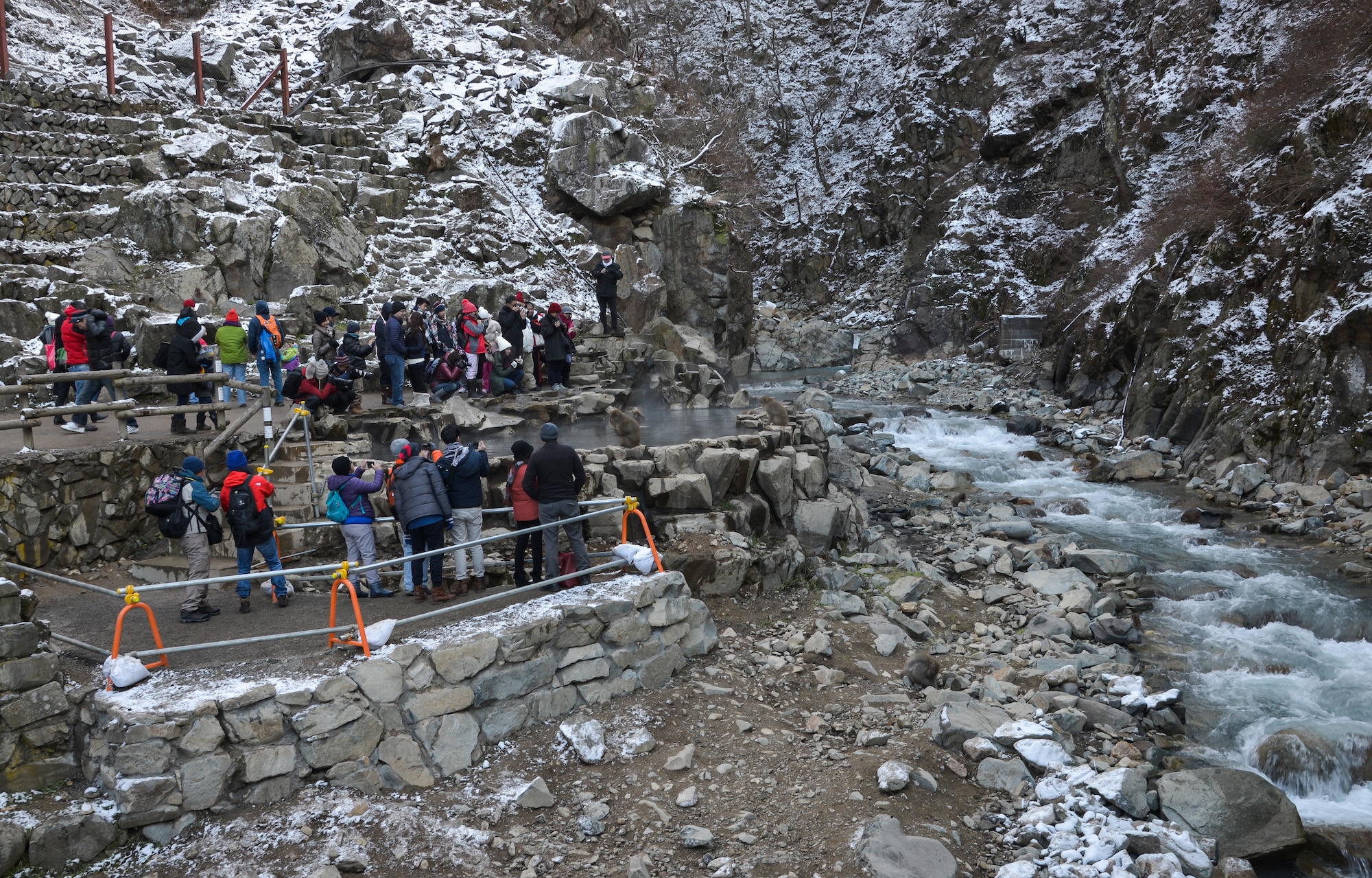 People watch and take pictures of Japanese macaque monkeys in a hot spring in Jigokudani Yaen-koen, Nagano, Japan, Dec. 26, 2015. The park was established in 1964 and has provided people with the opportunity to see the monkeys in their natural habitat. (U.S. Air Force photo by Senior Airman David Owsianka/Released)