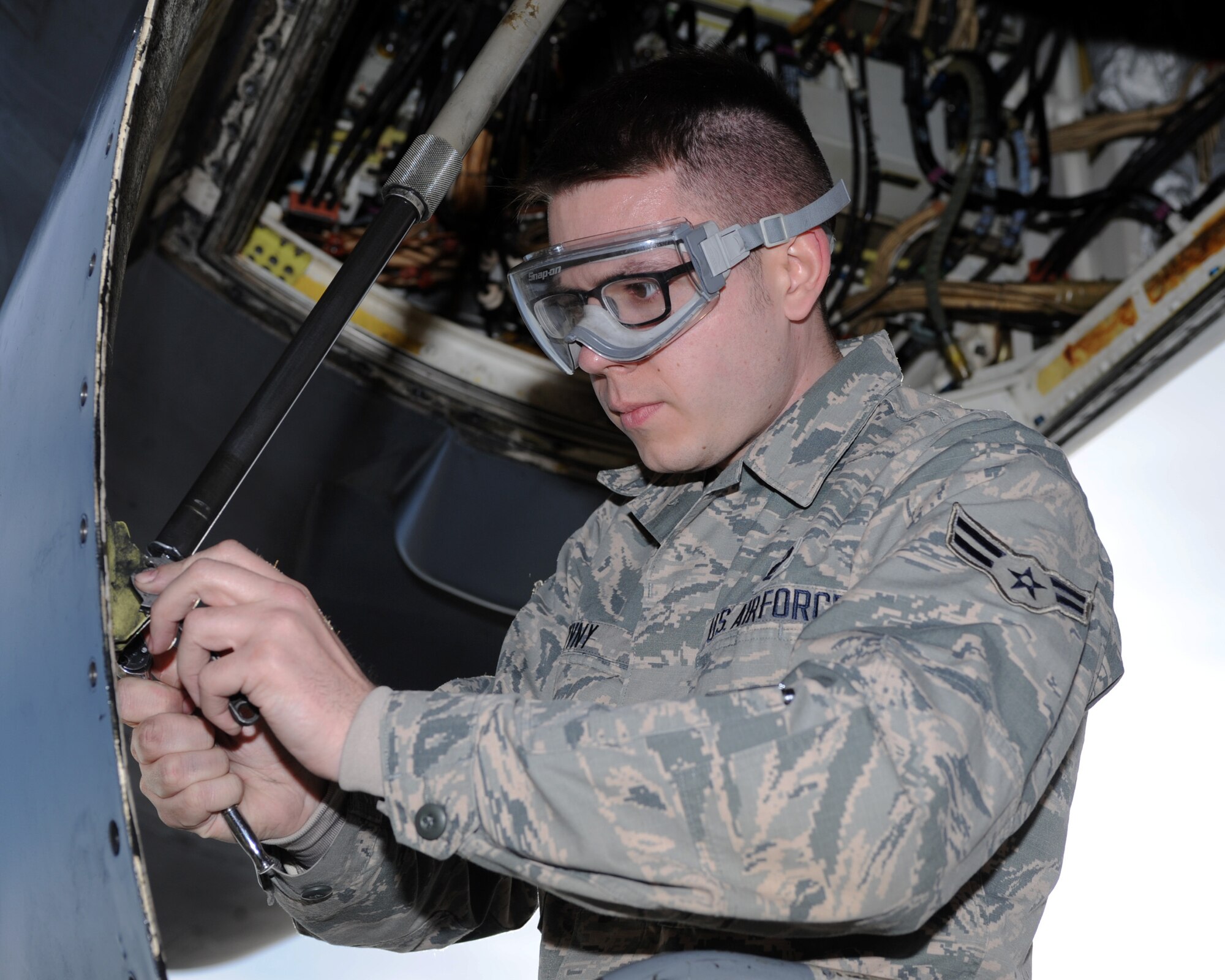 Airman 1st Class Christopher Zivny, 28th Aircraft Maintenance Squadron electronic warfare apprentice, removes a panel to replace grommets from a B-1 bomber as part of routine maintenance Jan. 5, 2016. The 28th AMXS performs regular maintenance to ensure all 27 aircraft in the 28th Bomb Wing’s fleet remain in working condition. (U.S. Air Force photo by Airman 1st Class Denise M. Nevins/Released)