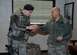 Capt. Benjamin Quintanilla, 28th Bomb Wing chaplain, right, hands a cup of hot chocolate to Airman 1st Class Taylor Tschida, 28th Security Forces Squadron response force member, at Ellsworth Air Force Base, S.D., Jan. 7, 2016. Chaplains provide many services including unit engagement as a way to boost Airmen morale. (U.S. Air Force photo by Airman 1st Class Denise M. Nevins/Released)