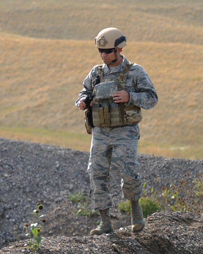 Capt. Benjamin Quintanilla, 28th Bomb Wing chaplain, looks around the 28th Civil Engineer Squadron explosive ordnance disposal training site at Ellsworth Air Force Base, S.D., Oct. 6, 2015. As a chaplain, Quintanilla visits squadrons to boost morale and meet with Airmen who may be having a rough time. (U.S. Air Force photo by Airman Sadie Colbert/Released)