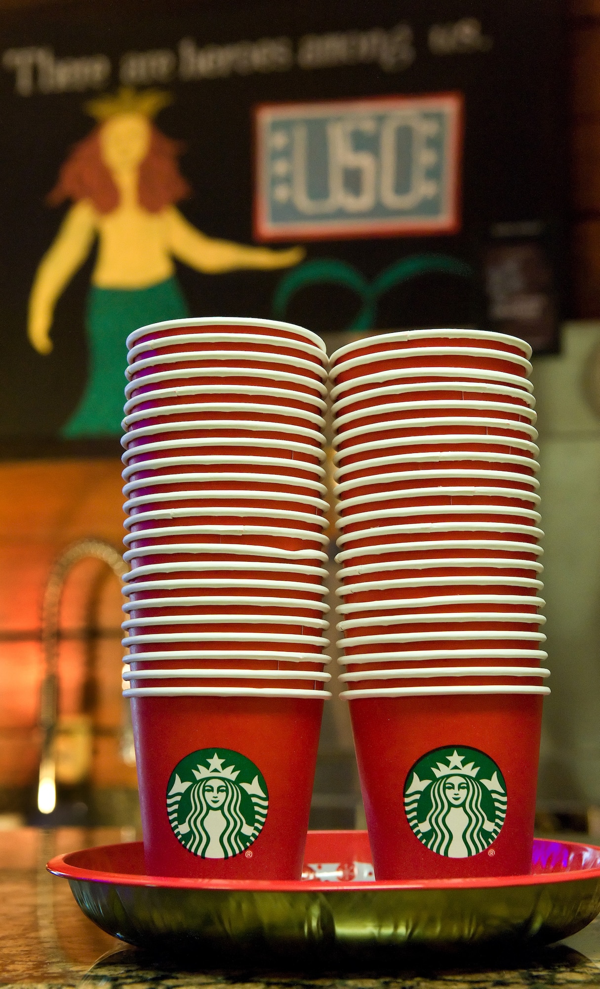 On behalf of Starbucks Coffee and Tea, a coffee brewer, consumables and a hand-drawn sign were delivered to the USO Delaware by Erika Endlein, Starbucks military store manager, Dover, Del., Jan. 7, 2016, at the USO Lounge on Dover Air Force Base, Del. The Starbucks located in Dover, Del., designated as a military family store, strives to employ active duty and reservists while they serve or transition out of the military, as well as employ spouses and veterans. (U.S. Air Force photo/Roland Balik)
