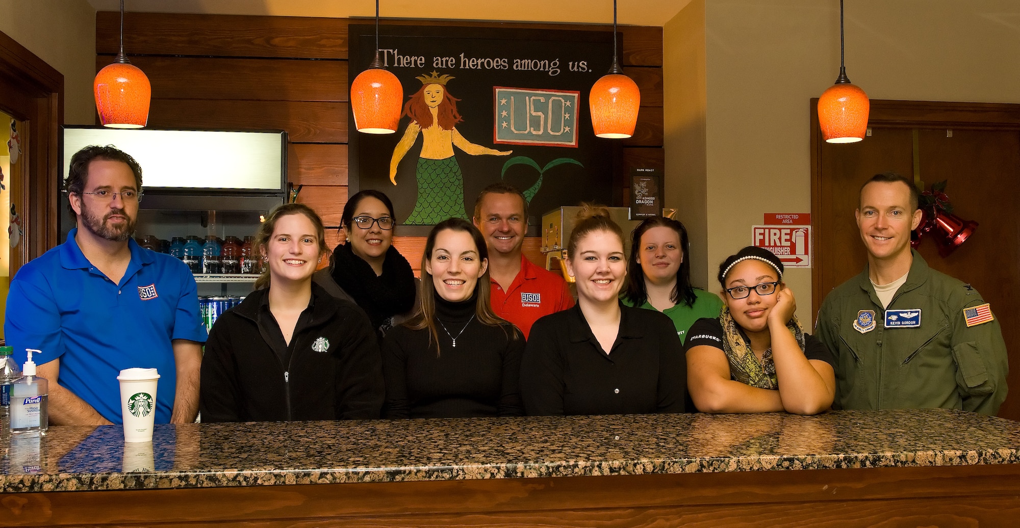 Col. Kevin Gordon, 436th Airlift Wing vice commander, right, stands with Starbucks military family store partners in Dover, Del. and members of USO Delaware Jan. 7, 2016, at the USO Lounge on Dover Air Force Base, Del. Erika Endlein, Dover Starbucks military family store manager, third from left, presented the USO with a coffee brewer and numerous consumables allowing USO volunteers to serve Starbucks coffee to patrons visiting the lounge. The partners pictured are also USO Delaware volunteers. (U.S. Air Force photo/Roland Balik)