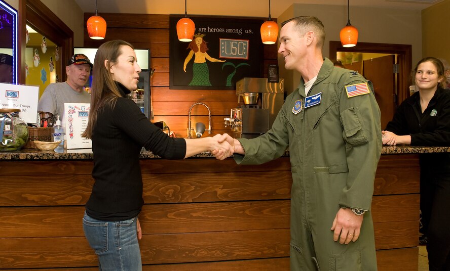 Col. Kevin Gordon, 436th Airlift Wing vice commander, right, thanks Erika Endlein, Starbucks military family store manager, Dover, Del., for supporting the USO Delaware and Team Dover, Jan. 7, 2016, at the USO Lounge on Dover Air Force Base, Del. Endlein, a military spouse herself, stated it is important to have a great connection with the base and employ active duty, Reserve, spouses and veterans as part of being a military family store. (U.S. Air Force photo/Roland Balik)