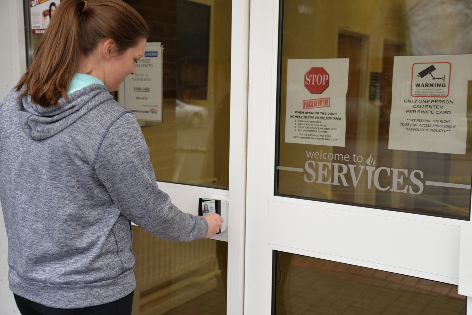U.S. Air Force Senior Airman Hope Kollauf, 100th Security Forces Squadron combined controller, scans her common access card to gain access to the Northside Fitness Center Jan. 7, 2016, on RAF Mildenhall, England. Team Mildenhall members can register to use the fitness center, which will eventually be completely unmanned. It is the only gym on RAF Mildenhall which is accessible on goal and family days, U.S. holidays, and after hours. For more information, call the Hardstand Fitness Center at DSN 238-3730 or commercial 01638-543730. (U.S. Air Force photo by Karen Abeyasekere/Released)