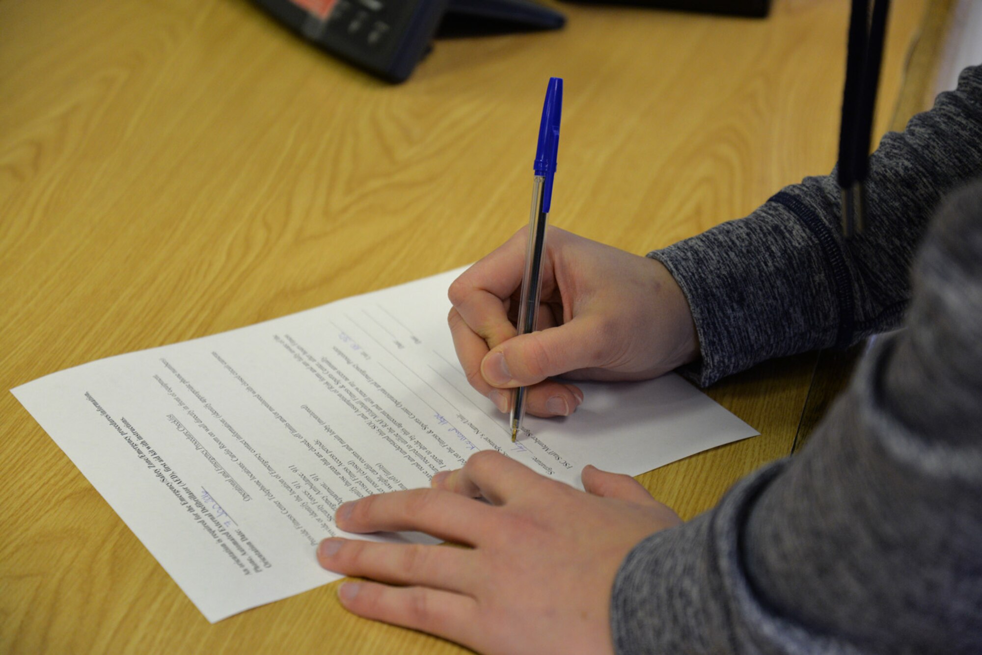U.S. Air Force Senior Airman Hope Kollauf, 100th Security Forces Squadron combined controller, completes the statement of understanding as part of registration for the Northside Fitness Center’s fitness access program Jan. 7, 2016, on RAF Mildenhall, England. Team Mildenhall members can register to use the fitness center, which will eventually be completely unmanned. It is the only gym on RAF Mildenhall which is accessible on goal and family days, U.S. holidays, and after hours. For more information, call the Hardstand Fitness Center at DSN 238-3730 or commercial 01638-543730. (U.S. Air Force photo by Karen Abeyasekere/Released)