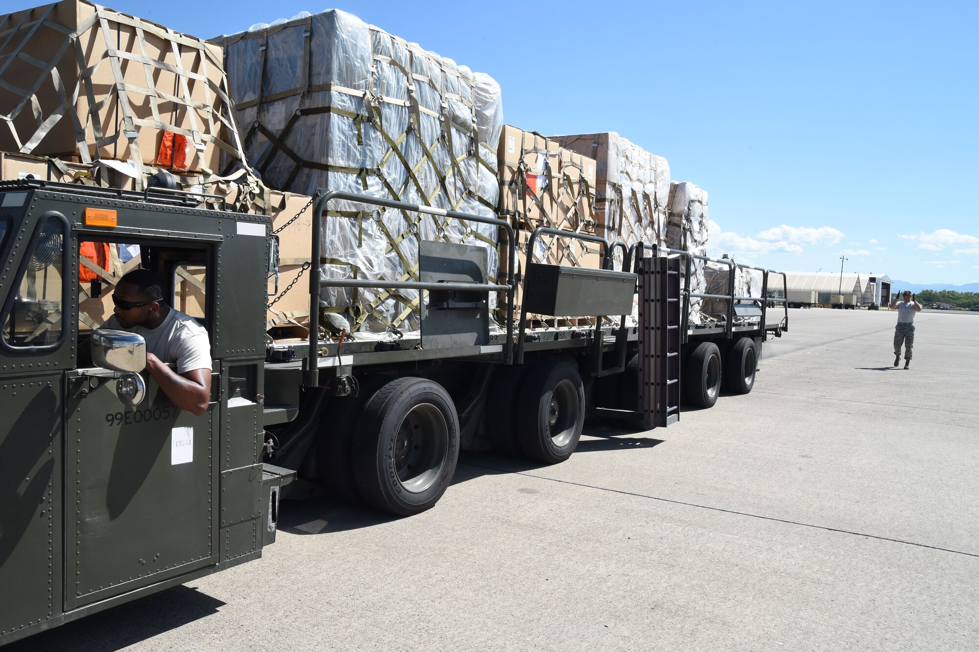 U.S. Air Force Staff Sgt. Jordan Woodward takes direction from Tech. Sgt. Jeffrey Kukuk, 612th Air Base Squadron, while unloading cargo from a U.S. Air Force C-130J Super Hercules cargo aircraft on Soto Cano Air Base, Honduras, Jan. 7, 2016. Members of the 612th and Joint Task Force-Bravo frequently aid in the delivery and handling of humanitarian aid cargo like that in this delivery. (U.S. Air Force photo by Martin Chahin/Released)