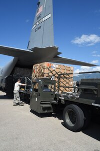 U.S. Air Force Tech. Sgt. Deavin Lee, 612th Air Base Squadron, unloads cargo from a U.S. Air Force C-130J Super Hercules  cargo aircraft on Soto Cano Air Base, Honduras, Jan. 7, 2016. The cargo was donated by Helping Hands Ministries and Operations Ukraine by use of the Denton Program. (U.S. Air Force photo by Martin Chahin/Released)