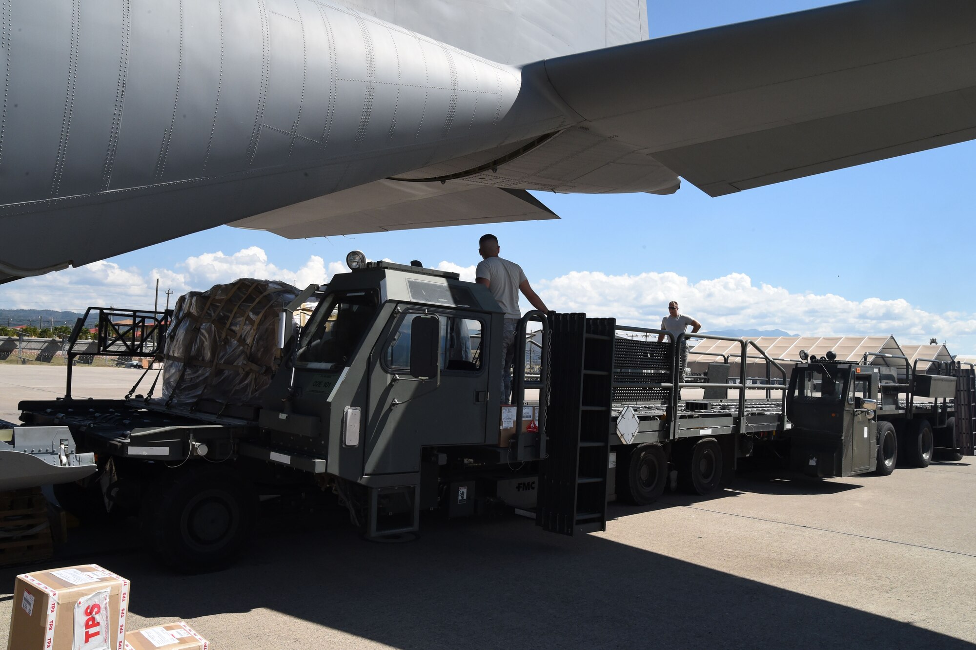 U.S. Air Force members assigned to the 612th Air Base Squadron unload cargo from a U.S. Air Force C-130J Super Hercules cargo aircraft on Soto Cano Air Base, Honduras, Jan. 7, 2016. The cargo was delivered  by use of the Denton Program, a program created to allow donated humanitarian goods the ability to use space available on military cargo aircraft. (U.S. Air Force photo by Martin Chahin/Released)