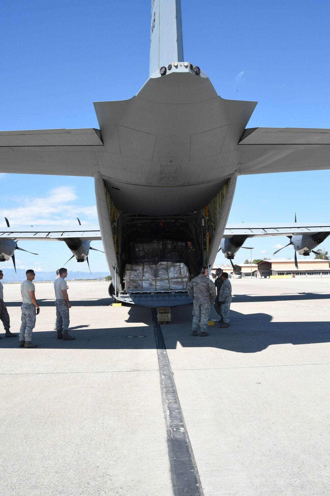 U.S. Air Force members assigned to the 612th Air Base Squadron unload cargo from a U.S. Air Force C-130J Super Hercules cargo aircraft on Soto Cano Air Base, Honduras, Jan. 7, 2016. The cargo was delivered by use of the Denton Program, a program created to allow nonprofit organizations the ability to transport donated humanitarian goods via space available on military cargo aircraft. (U.S. Air Force photo by Martin Chahin/Released)
