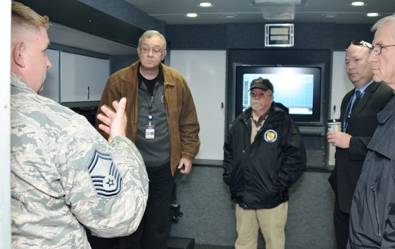Maryland Emergency Management Agency (MEMA) Regional Liaison Officers (RLO) and the Maryland Coordination and Analysis Center (MCAC) director listen to Senior Master Sgt. Matt Crabill, 175th Emergency Management Superintendent, describe the capabilities of the Mobile emergency Operations Center (MEOC) that the Maryland Air National Guard deploys from Warfield Air National Guard Base in Baltimore for FEMA region three. The representatives were at 175th Wing to talk to Airmen who would deploy the asset to an emergency or other event as needed. (U.S. Air National Guard photo by Tech. Sgt. David Speicher/RELEASED)