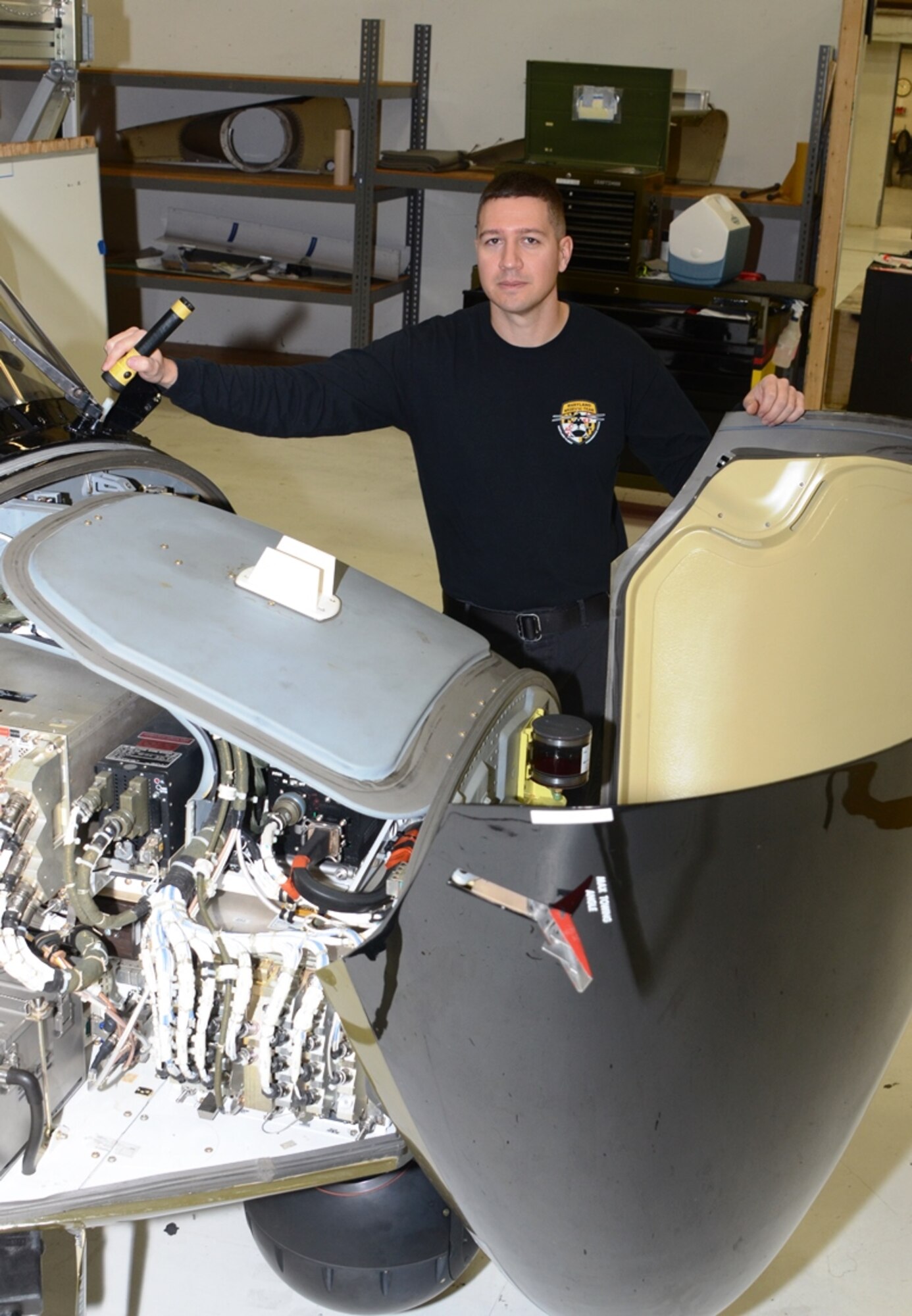 Tech. Sgt. Timothy Dash stands by the front of a Maryland State Police Helicopter in a hanger for maintenance at Martin State Airport in Baltimore December 4th. Dash is the 175th Wing Spotlight Airman for January 2016. In his civilian job, Dash is a Maryland State Police helicopter mechanic. (U.S. Air National Guard photo by Tech. Sgt. David Speicher/RELEASED)
