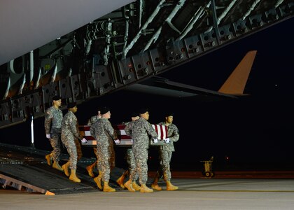 A U.S. Army carry team transfers the remains of Staff Sgt. Matthew Q. McClintock, of Albuquerque, N.M., during a dignified transfer Jan. 8, 2016, at Dover Air Force Base, Del. McClintock was assigned to the 1st Battalion, 19th Special Forces Group, Buckley, Wash. (U.S. Air Force photo/Senior Airman Class William Johnson)